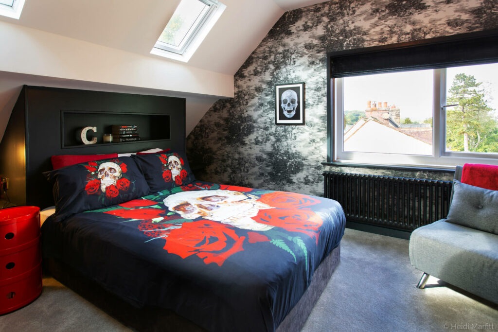 Inky greys and skull patterned accessories turned this attic bedroom into a gothic retreat