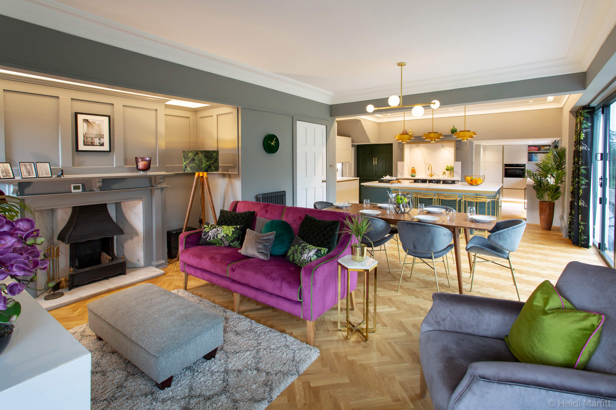 A cosy purple sofa means there is space to chill out in this stylish family kitchen
