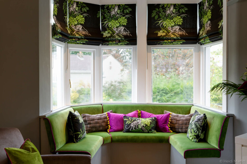 Fresh green velvet makes this window seat a perfect spot