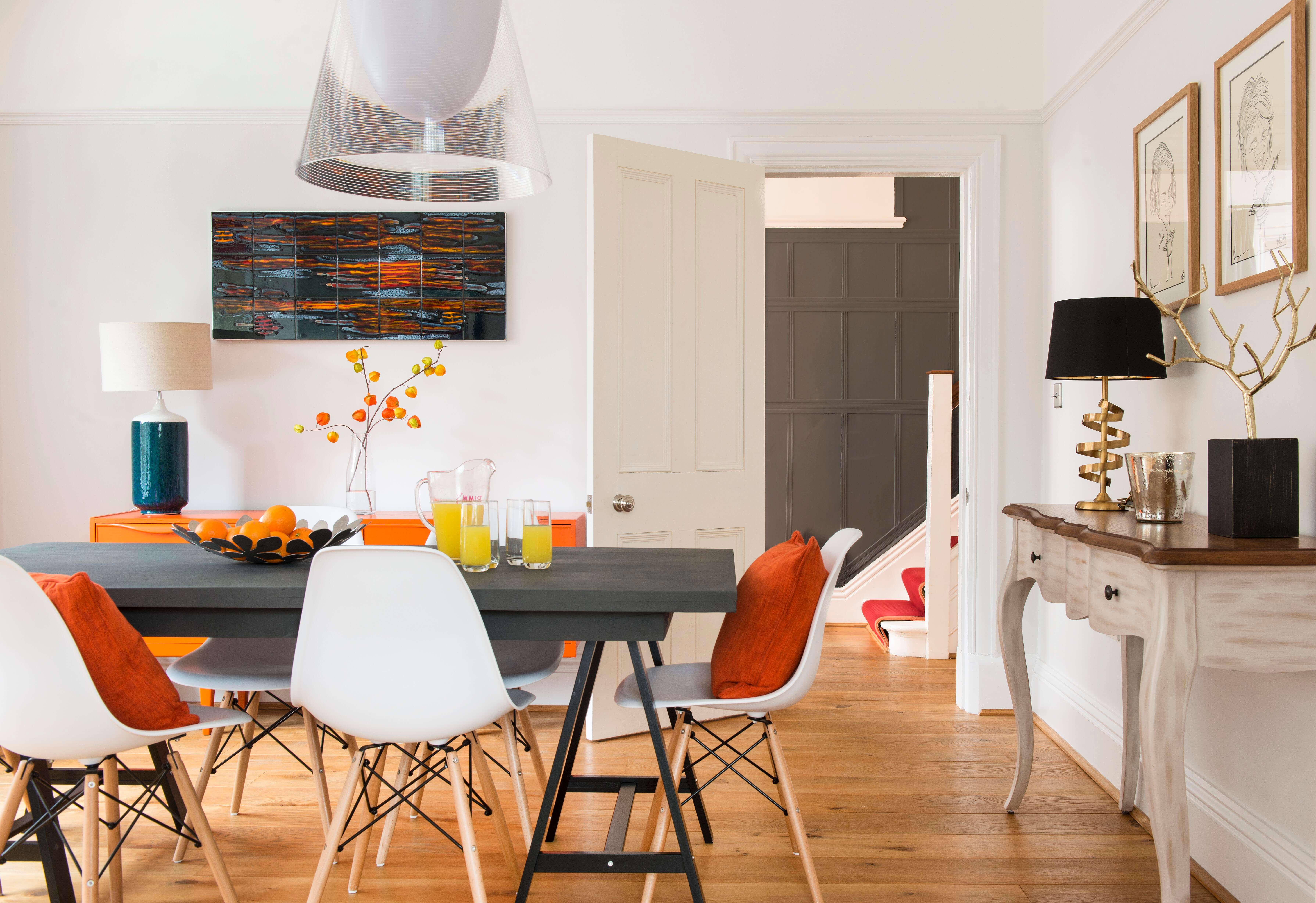 Bright orange pops bring this busy family dining room to life
