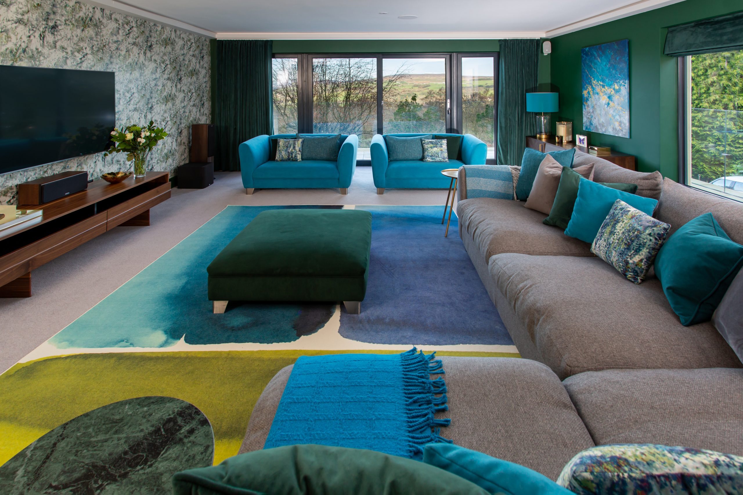 Contemporary living room, green walls, botanical wallpaper and rug reflecting the greens and blues in the room
