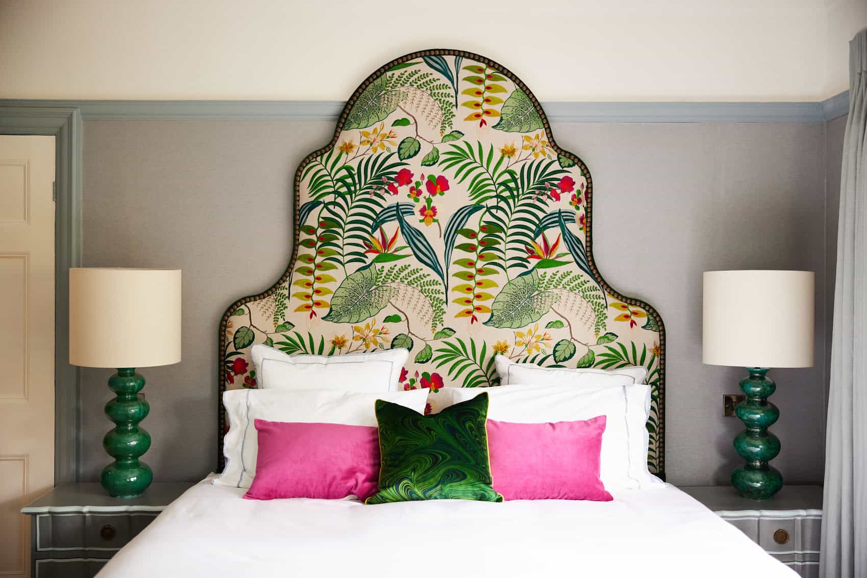 ILKLEY3_AMC_JUNE2023 104 AMC Design designed this bespoke shaped headboard, which added pattern and texture to this pale blue master bedroom. The green bedside lights and green Susi Bellamy cushion on the bed echo the colours of the headboard, adding harmony and balance to the room.